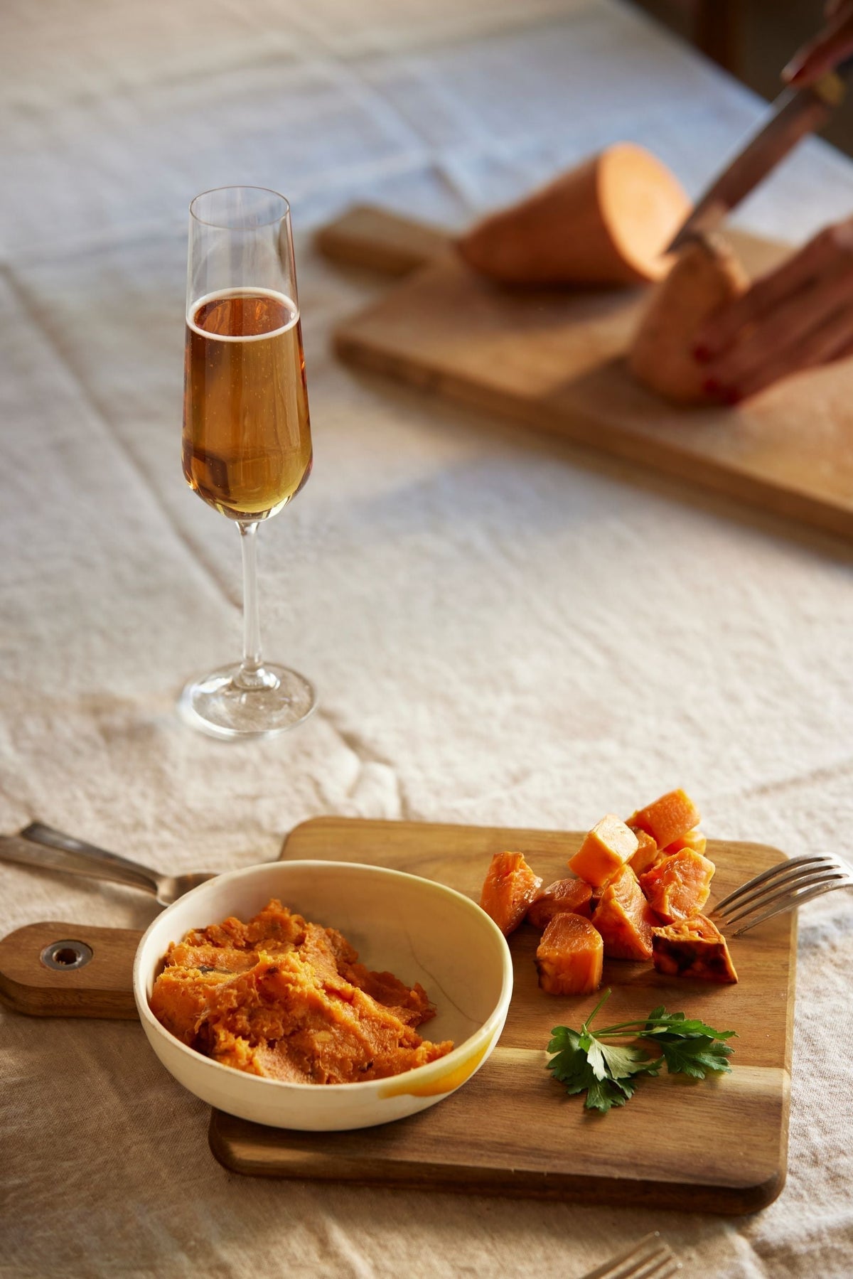Glas alcoholvrije sparkling tea met zoete aardappel op houten plank, tafelsetting | World of NIX