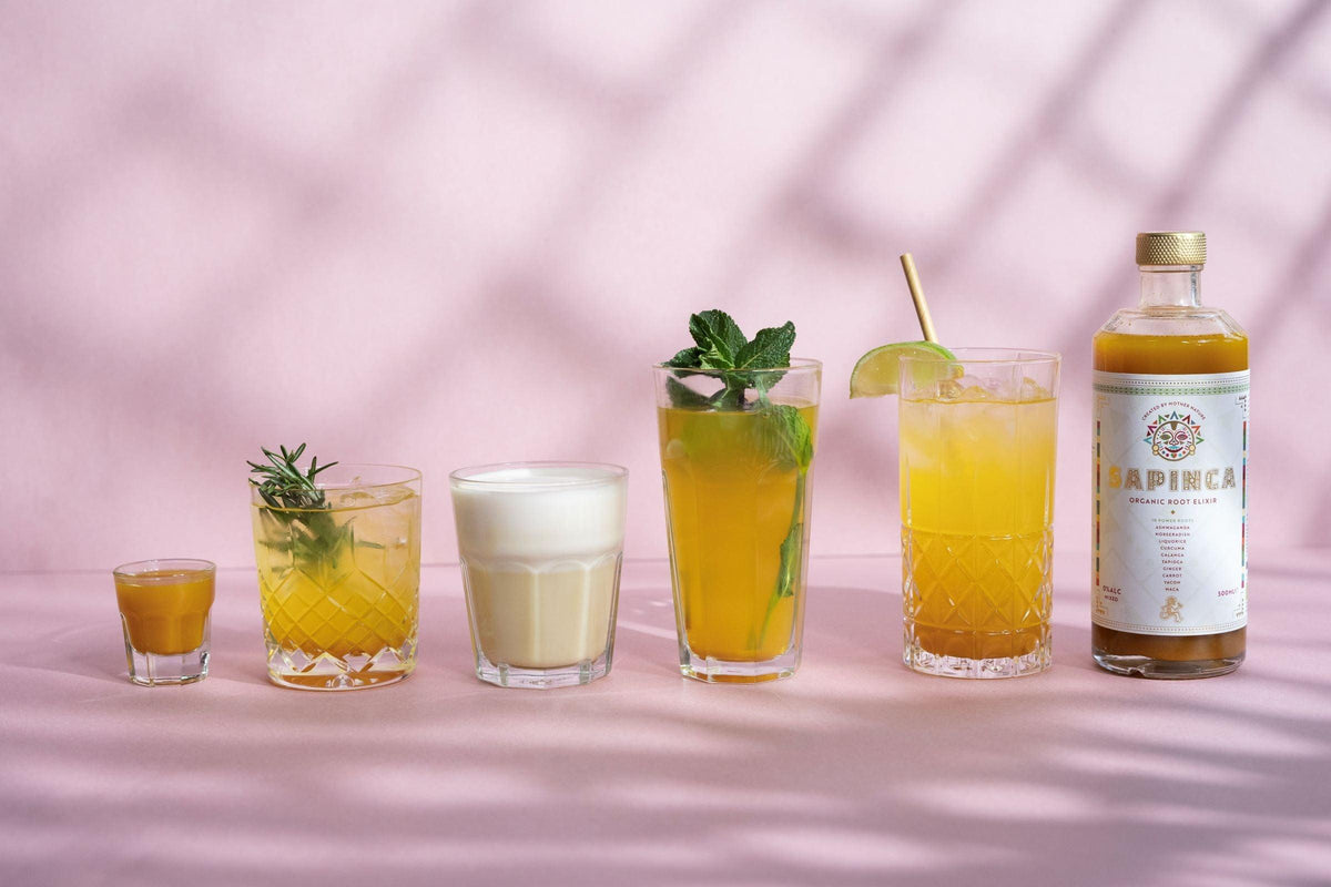 Verschillende alcoholvrije gembercocktails met Sapinca fles op roze achtergrond | World of NIX
