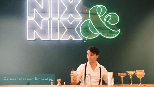 Barman maakt alcoholvrije cocktails aan bar bij NIX & NIX neonbord | World of NIX